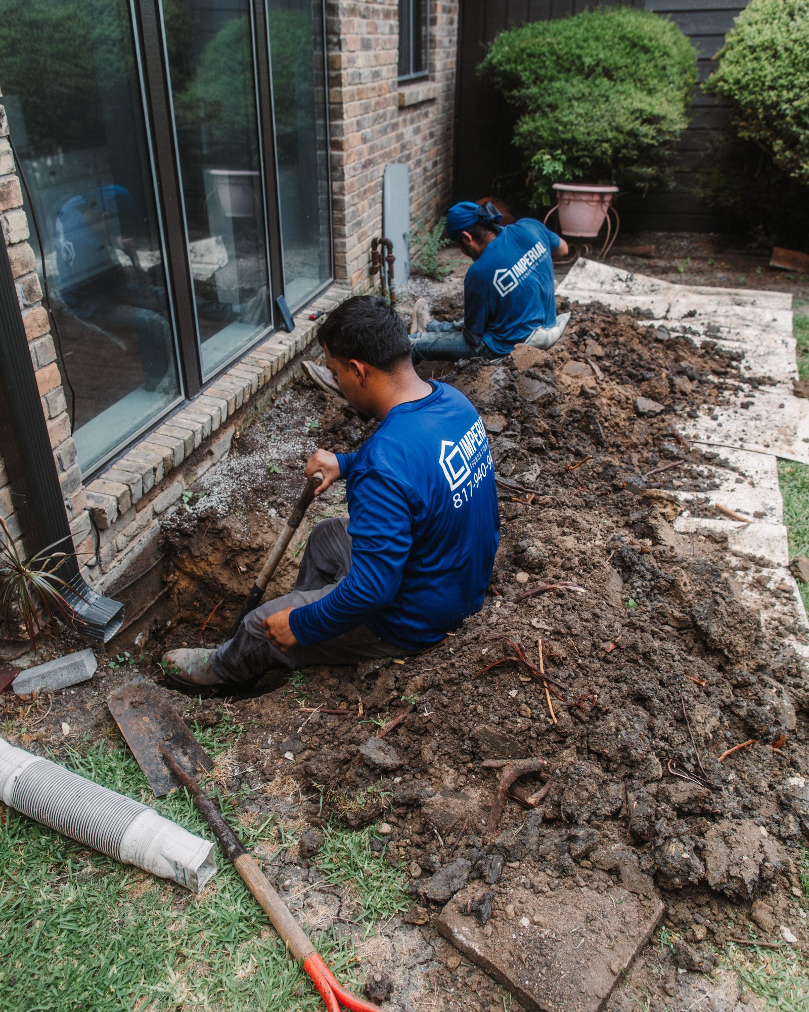 Crew tunneling at windows, Imperial Foundation Repair job site in North Texas