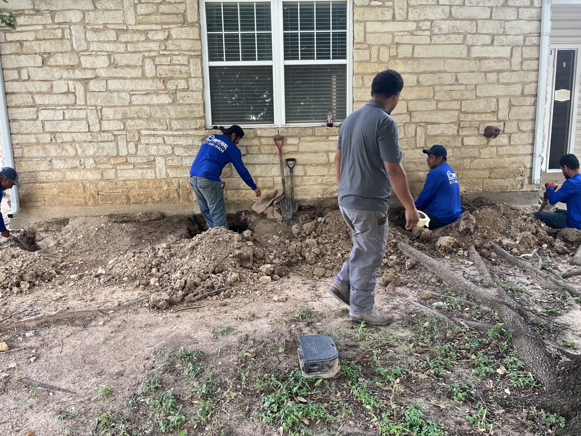 Crew excavation limestone, Imperial Foundation Repair job site in North Texas