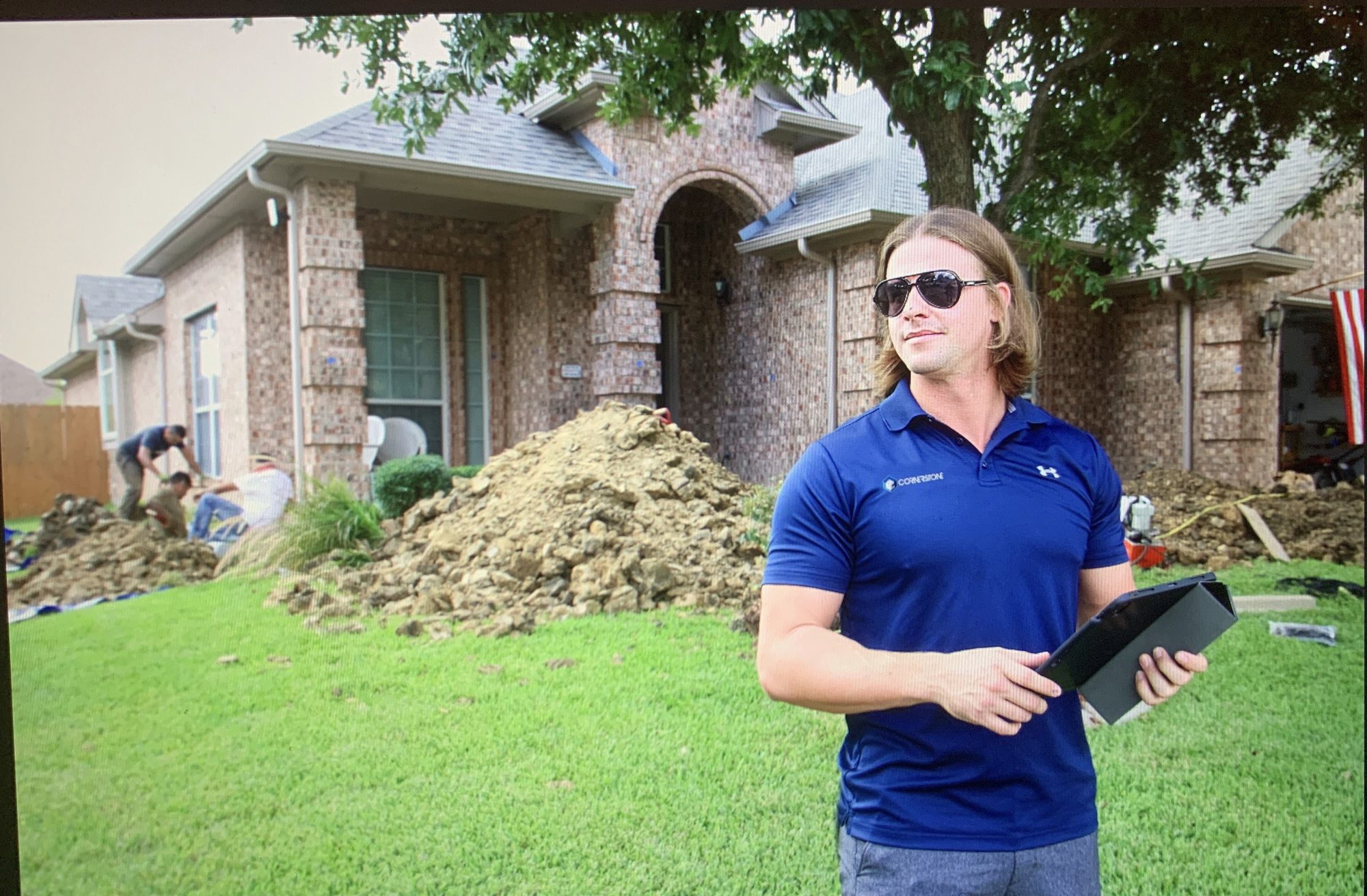 Rep portrait with tablet, Imperial Foundation Repair job site in North Texas