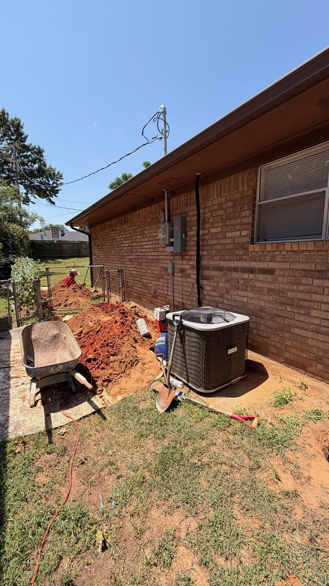 Trench alongside house, Imperial Foundation Repair job site in North Texas
