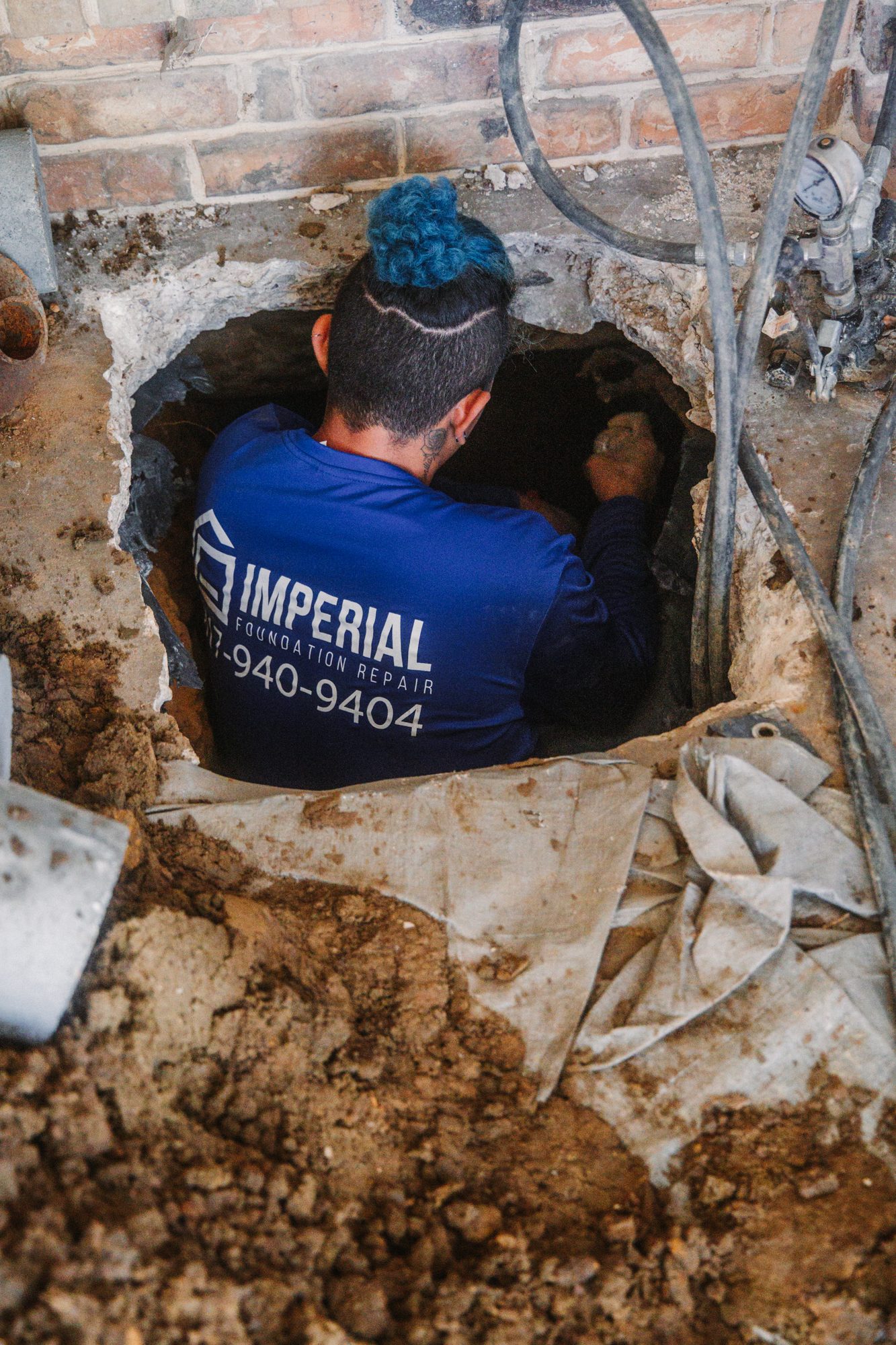 Tunnel worker branded, Imperial Foundation Repair job site in North Texas