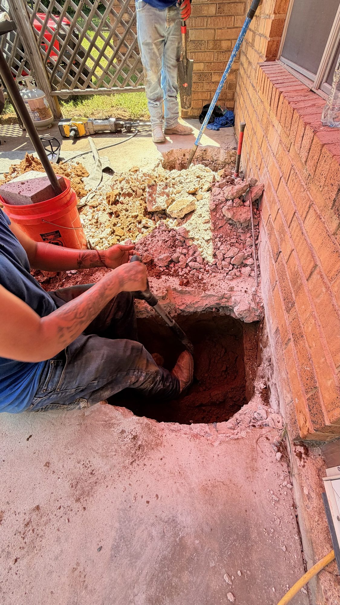 Patio pier hole dig, Imperial Foundation Repair job site in North Texas