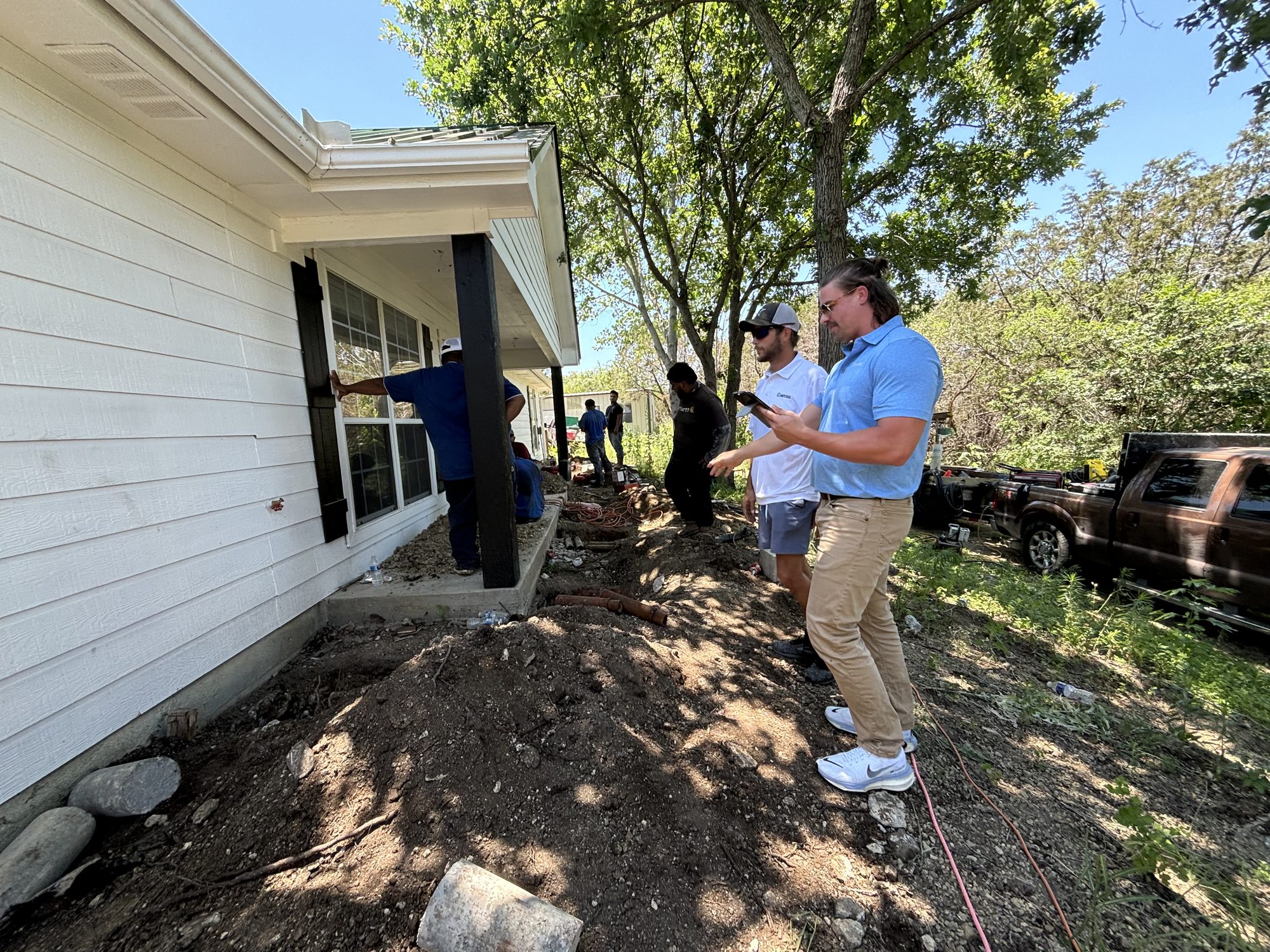 Rep inspecting with crew, Imperial Foundation Repair job site in North Texas