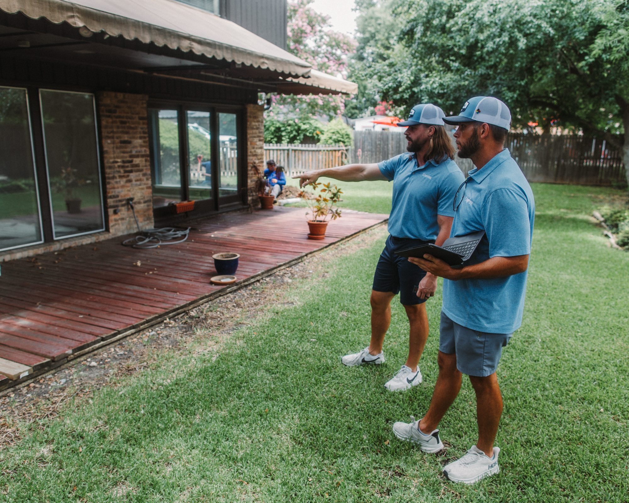 Rep and homeowner pointing, Imperial Foundation Repair job site in North Texas
