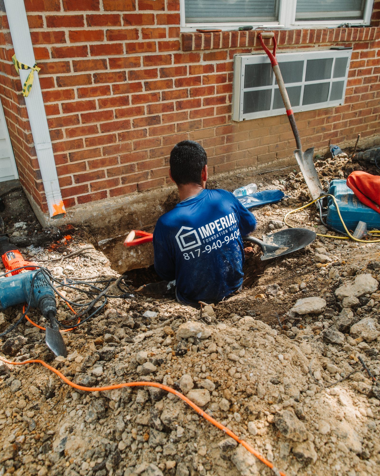Pier install hydraulic ram, Imperial Foundation Repair job site in North Texas