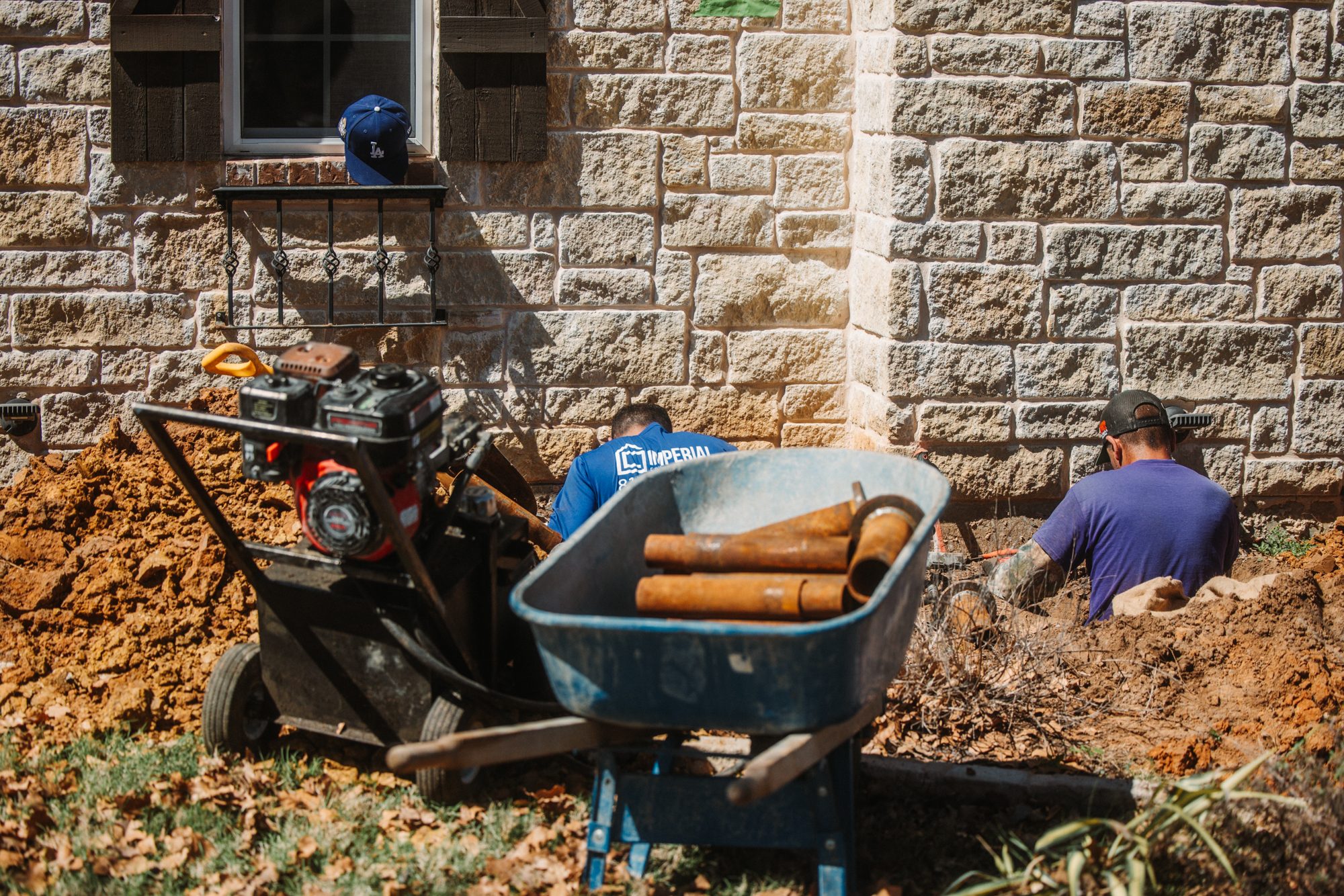 Steel piers wheelbarrow with pump, Imperial Foundation Repair job site in North Texas